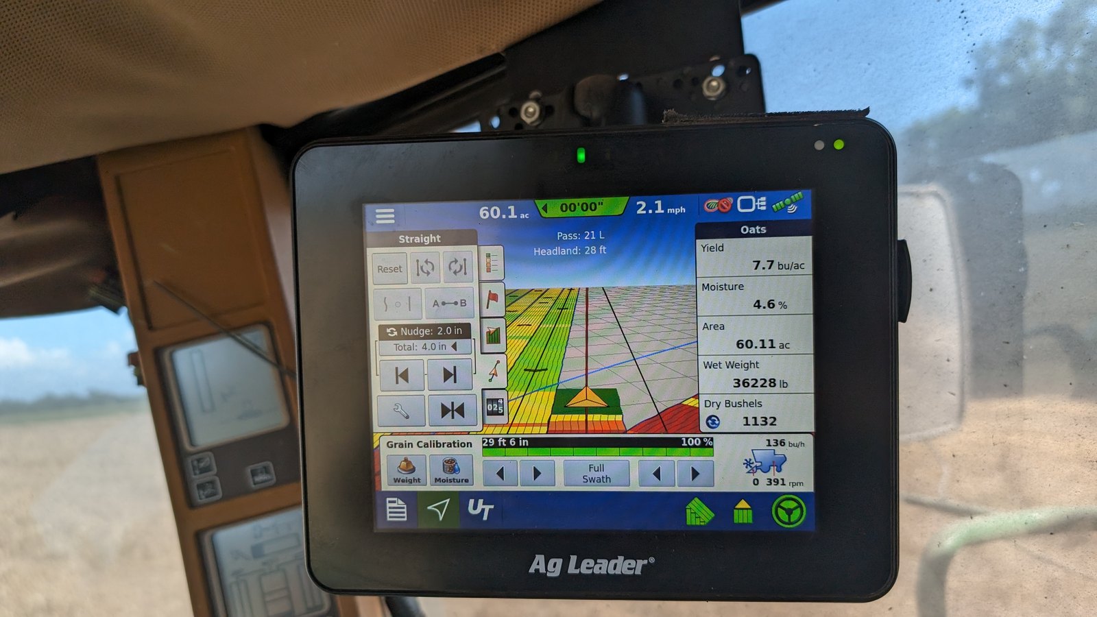 An Ag Leader display in a combine cab showing grain calibration figures at harvest